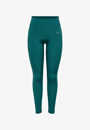 Leggings de sport taille haute couleur sarcelle avec un petit logo réfléchissant sur la partie supérieure de la cuisse gauche, conçus pour un ajustement près du corps.