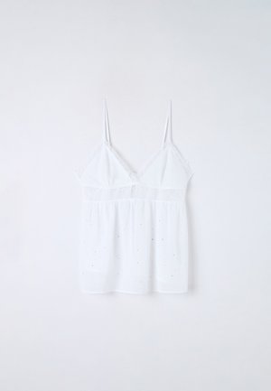 Camisole bianco con spalline sottili, dettagli in pizzo nella parte superiore e un corpo morbido con piccole decorazioni sparse.
