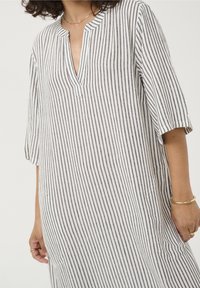 Robe en lin rayée avec un décolleté en V, des manches courtes et des poches latérales. Les rayures sont grises et blanches, avec une coupe décontractée.