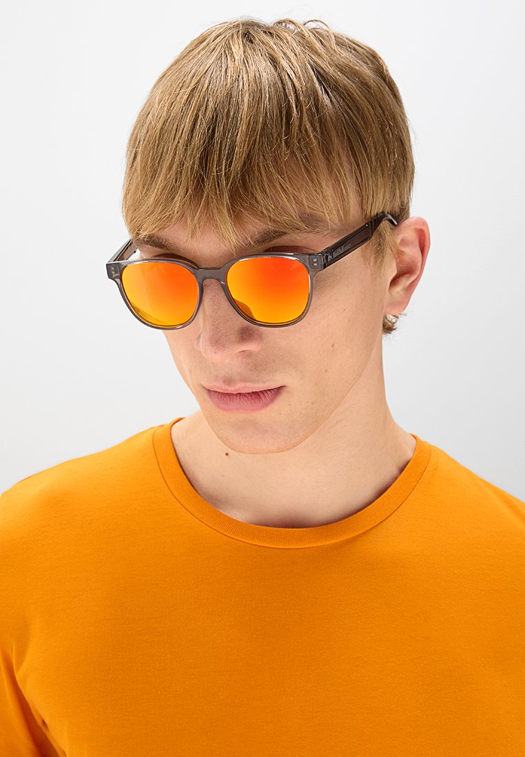 Okulary przeciwsłoneczne z szarymi oprawkami, pomarańczowymi lustrzanymi soczewkami i prostokątnym kształtem. W zestawie z gładką, pomarańczową koszulką.
