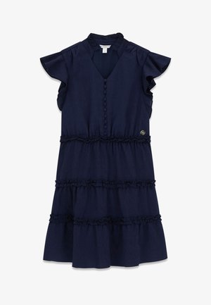 Tmavomodré námornícke šaty bez rukávov s volánovými vrstvami, gombíkmi pokrytými rovnakou látkou na prednej strane a malým kovovým logom na páse.