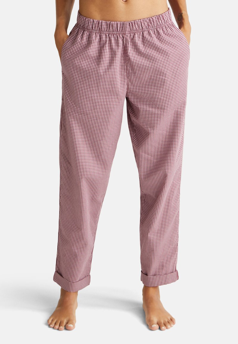 Rode en witte geruite pyjamabroek met een elastieken tailleband, losse pasvorm en omgeslagen manchetten. Lichte stof met een zachte textuur.