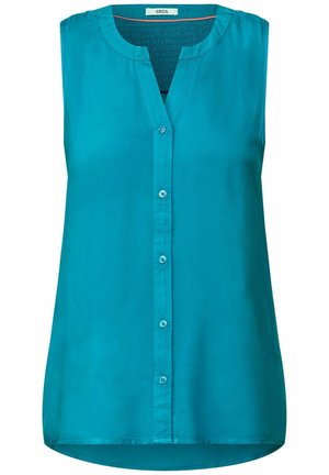 Blouse sans manches en teal avec un décolleté en V, patte de boutonnage sur le devant et tissu lisse et léger avec un ourlet arrondi.