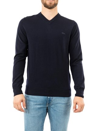 Pullover V-neck blu navy realizzato in tessuto morbido, con maniche lunghe e orlo a costine. Dettaglio logo discreto sul petto.