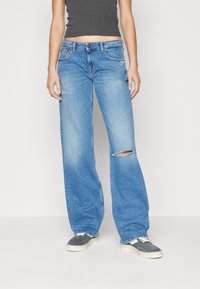 Light blue, wide-leg jeans made of denim, featuring a distressed knee detail, five-pocket design, and a button closure.