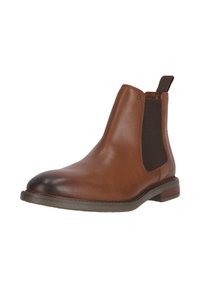 Ruskokoinen nahkainen Chelsea-saapas, jossa on joustavat sivupaneelit, pyöreä kärki ja matala pino. Pohja on hieman läpikuultava.