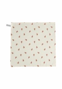 Beige auduma salvetes ar atkārtotu mazu piparkūku cilvēku rakstu, kas valkā sarkanus un baltus Ziemassvētku cepures.