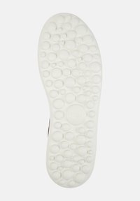 White rubber shoe sole featuring a textured pattern of raised bubbles; central branding “camper” embossed in the middle.