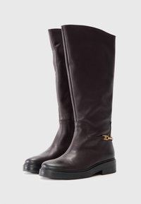Bottes en cuir marron, hautes jusqu'aux genoux, avec une texture lisse, un bout arrondi et une semelle en caoutchouc noir, avec un accent doré sur le côté.