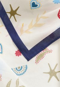 Colorful scarf featuring a white background with abstract patterns in blue, red, gold, and pink, bordered by a dark navy edge.