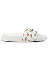 White slide sandal featuring a textured strap with a pineapple pattern and logo, flat sole, and minimalist design.