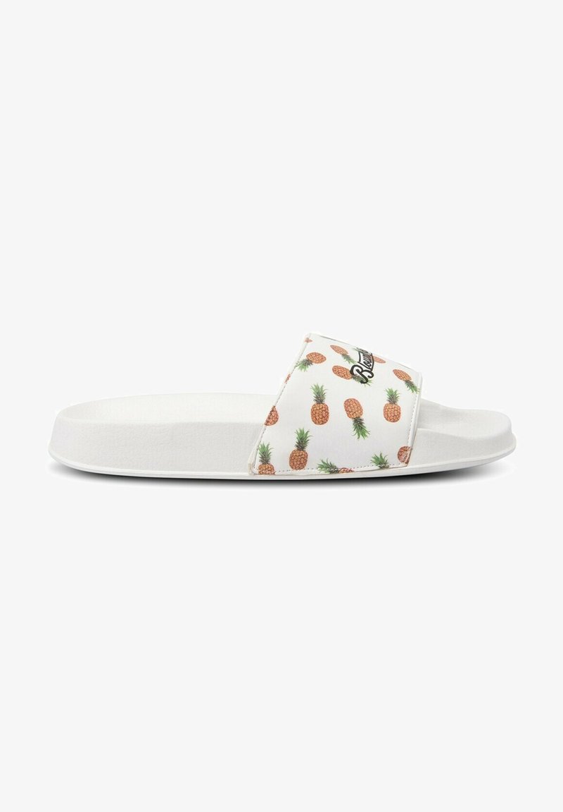 White slide sandal featuring a textured strap with a pineapple pattern and logo, flat sole, and minimalist design.