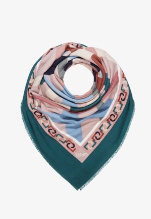 Foulard carré plié en triangle avec des motifs géométriques multicolores en turquoise, rose, bleu et marron, bords frangés et logo de la marque.