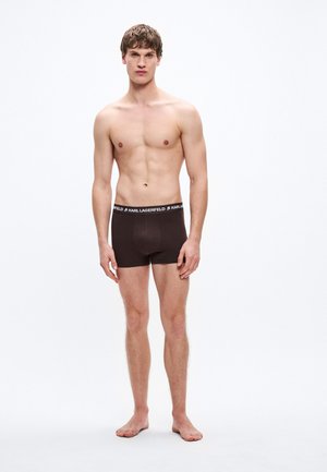 Calzoncillos bóxer de algodón marrón con una cinturilla negra que lleva el logotipo "KARL LAGERFELD", diseño ajustado, textura suave y longitud hasta la mitad del muslo.