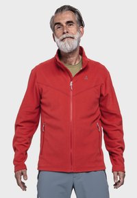 Rote Fleecejacke mit Reißverschluss an der Vorderseite, seitlichen Taschen und grauen Akzenten. Verfügt über einen hohen Kragen und ein Logo im linken Brustbereich.