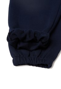 Dunkelblaue Jogginghose mit gerippten Bündchen und elastischem Bündchen, aus einem weichen, strukturierten Stoff gefertigt. Schlichtes Design ohne Muster oder Akzente.