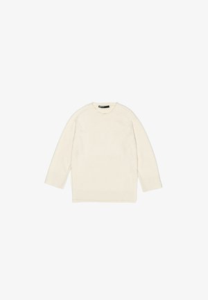 Helle, lange Strickjacke in Cremefarbe mit rundem Halsausschnitt, gerippten Bündchen und strukturierter Oberfläche. Verfügt über Seitenschlitze am Saum für mehr Bewegungsfreiheit.