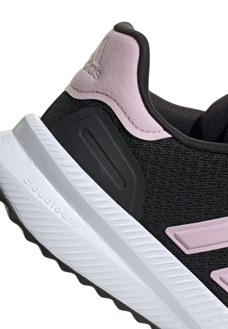 Black athletic shoe with a textured mesh upper, pink accents on the heel and logo, and a white Cloudfoam midsole, featuring a patterned outsole.
