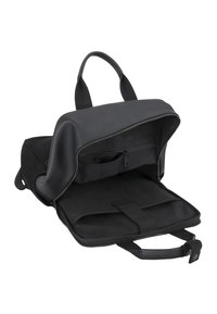 Black backpack with a smooth exterior and zippered closure. Interior features one zip pocket and a compartment with a secure strap.