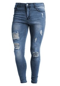 Eng anliegende blaue Jeans aus Denim mit mehreren verwaschenen Stellen und ausgefransten Kanten, im taillierten Schnitt und klassischem Fünf-Taschen-Design.
