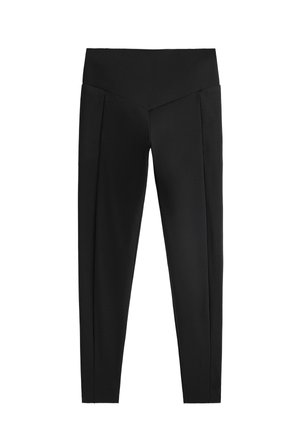 Leggings nere con una vita alta, caratterizzate da una texture liscia e pieghe su entrambi i lati. Il design è aderente lungo le gambe.