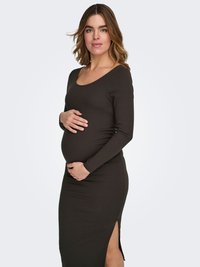 Graviditetstøj i mørkegrønt ribbet stof med lange ærmer, rund halsudskæring, tætsiddende design og sideslidser for neden.