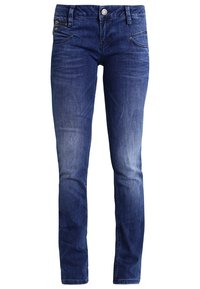 Jeans de denim azul oscuro con corte ajustado, que presentan bolsillos frontales y un detalle de bolsillo con cremallera. Textura suave con ligeras decoloraciones en los muslos.