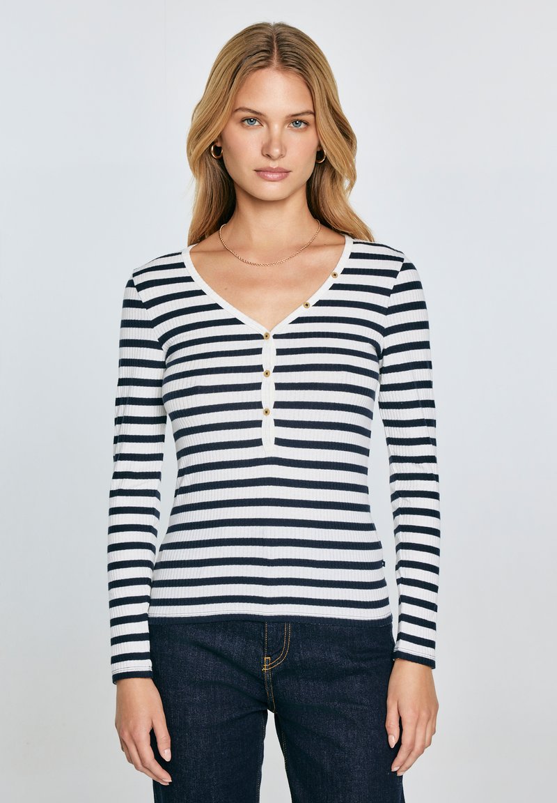 Langärmliges, navy- und weißgestreiftes, geripptes Shirt mit V-Ausschnitt und drei goldenen Knopf-Akzenten auf der Vorderseite. Dehnbare Stoff, figurbetonter Schnitt.