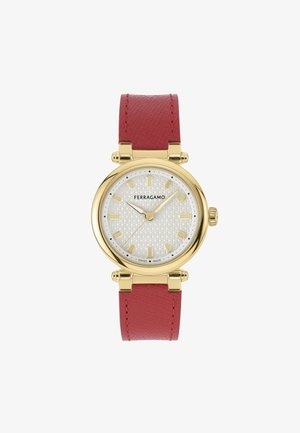 Aranyszínű óra texturált ezüst számlappal, arany mutatókkal és órák jelzőivel. Piros bőr szíj; svájci gyártmány, kerek arany tok.