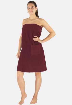 Burgundy towel dress with a textured finish, strapless design, and a front pocket. Features a knee-length cut and hemline.