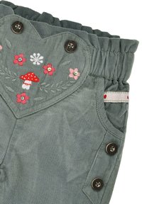 Gray corduroy pants with a heart-shaped pocket featuring red and pink floral embroidery and a mushroom design, with button accents.