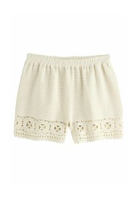 Krémové kraťasy vyrobené z texturované tkaniny, s krajkovým lemem s kruhovými vzory podél spodního okraje. Elastický pas pro lepší přizpůsobení.