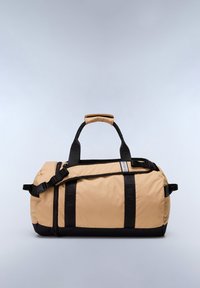 Beige duffle bag with black straps and accents, featuring a padded handle, zipper closure, and a contrasting bottom section.