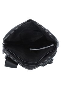 Black zippered handbag with a fabric interior, featuring multiple compartments and a smooth texture. Zipper detail visible along the top edge.