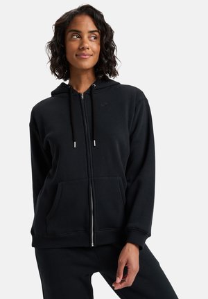 Haut de sweatshirt zippé noir en tissu doux, doté d'une capuche, de deux poches avant et d'un petit logo sur la poitrine. Design simple avec des poignets côtelés.