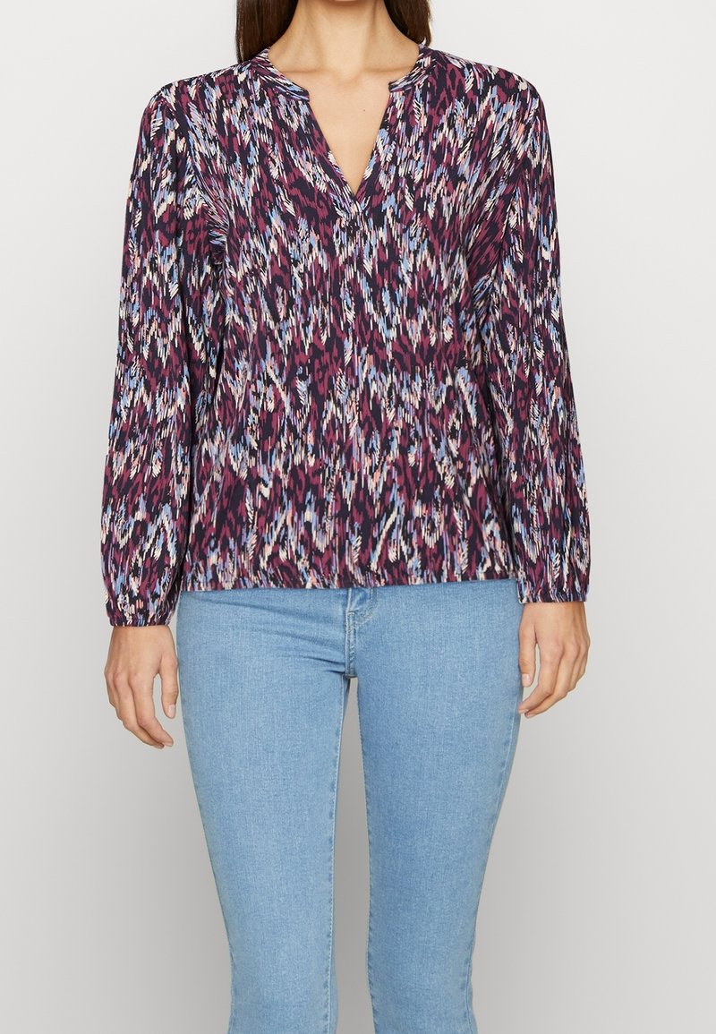 Long-sleeve blouse in patterned fabric with shades of purple, blue, and pink; v-neckline and gathered cuffs; relaxed fit.