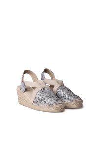 Silver and black patterned espadrille wedges with beige cross straps and a jute sole. Features a rounded toe and textured surface.