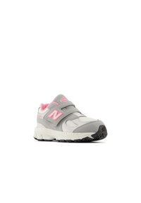 Gray athletic shoe with pink accents, dual Velcro straps, textured suede and mesh material, cushioned sole, and patterned rubber outsole.