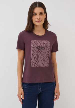 Purple cotton t-shirt with a round neck and short sleeves. Features a square graphic of palm leaves in a lighter shade with text below.