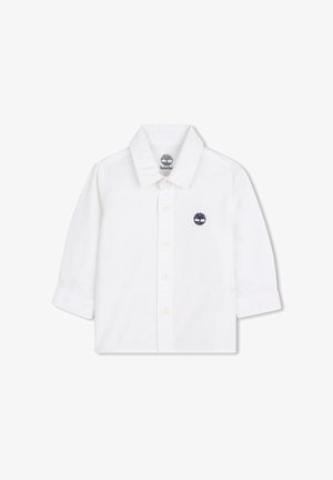 Chemise blanche à manches longues en coton, avec un col boutonné, des boutons sur le devant et un logo brodé bleu marine.