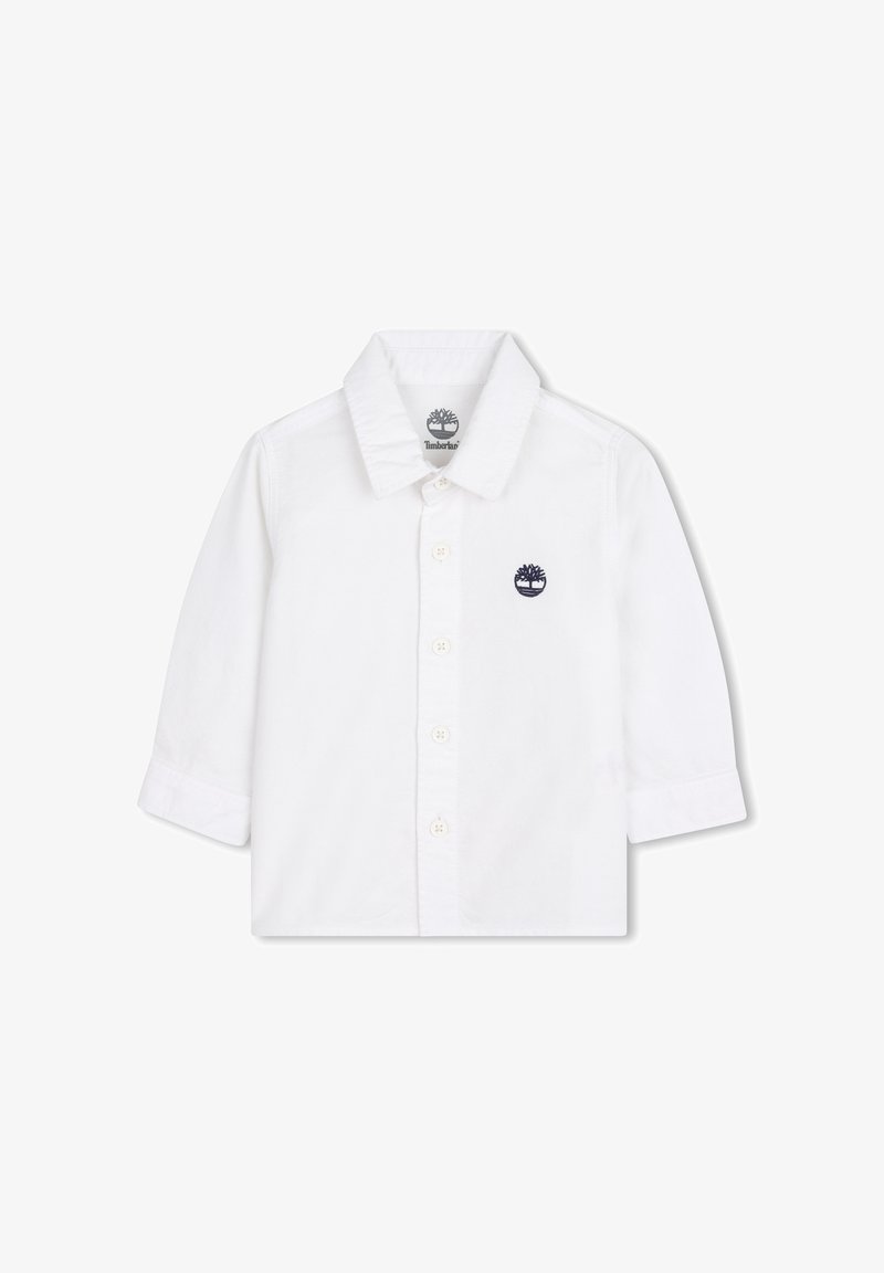 Chemise blanche à manches longues en coton, avec un col boutonné, des boutons sur le devant et un logo brodé bleu marine.