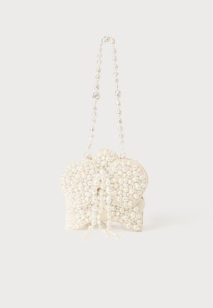 White handbag featuring a textured surface adorned with numerous white pearl-like beads, shaped with a distinctive bow design and a beaded strap.