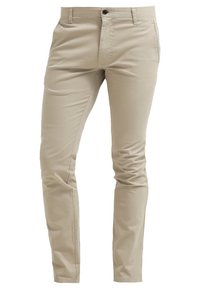 Beige chino kalhoty vyrobené z bavlněné směsi. Slim fit s klasickým pěticípým designem, zapínání na knoflík a hladká textura.