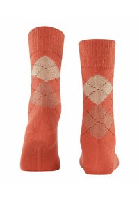 Calze corallo con un motivo a rombi beige, in texture lavorata a maglia, lunghezza alla caviglia con bordo a costine nella parte superiore. Tessuto morbido per il comfort.