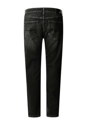 Mustad teksapüksid kahe tagataskuga ja vöökoha sildiga, nähtavad tagantpoolt valgel taustal.