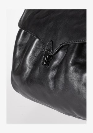 Zwarte leren tas met klepsluiting, vastgemaakt door een zwarte metalen gesp, met een close-up van gladde en gestructureerde leren oppervlakken.