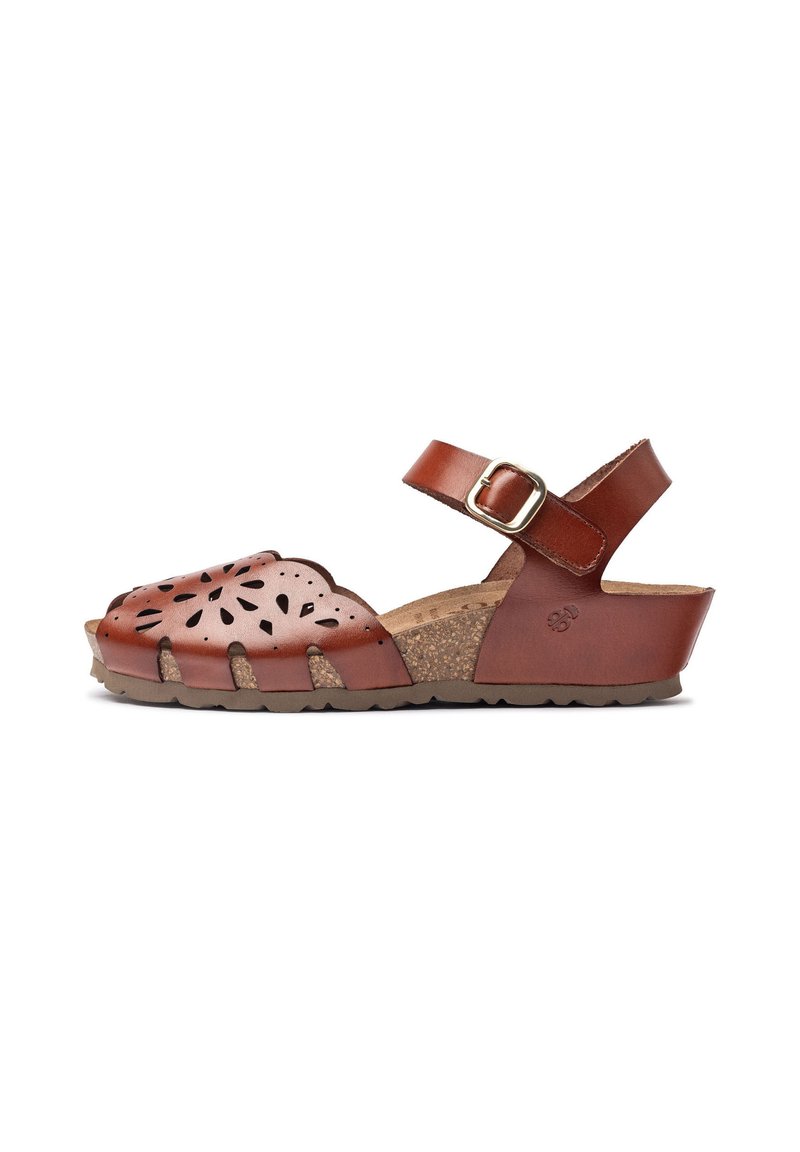 Brown leather sandal featuring a scalloped, perforated design, adjustable ankle strap, cork footbed, and textured rubber sole.