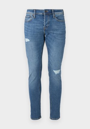 Jeans de mezclilla azul deslavado con corte Slim, que presentan zonas desgastadas en las rodillas, cierre de botón y diseño de cinco bolsillos.