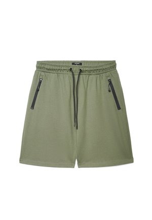 Shorts casual verde chiaro con vita elastica, coulisse nere e due tasche frontali con zip, distesi su uno sfondo bianco.