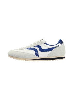 Biało-szary zamszowy trampek z niebieskim falistym detalem, beżową podeszwą z czarnym paskiem oraz białymi sznurowadłami, widok z boku.